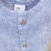 رامپر نوزادی H&M کتان راهراه آبی روشن بدون آستین با دکمه جلو
